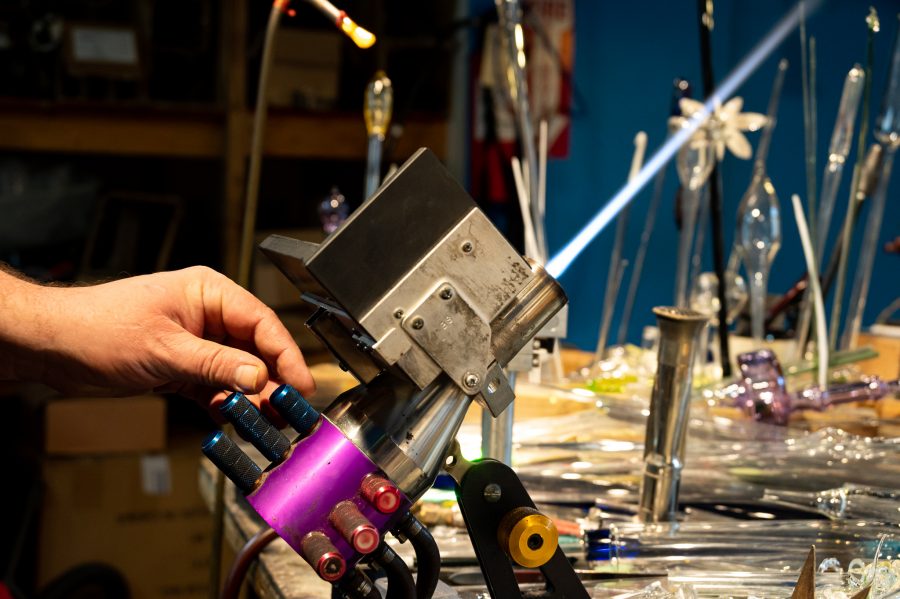 Skye Norton heats up a GTT torch at Kind Creations Nov. 9. When talking about the torch Norton explained, “there’s three knobs per stage, while most torches only have two knobs per stage.” This third knob allows for more flame control. (Milo Gladstein | The Collegian)