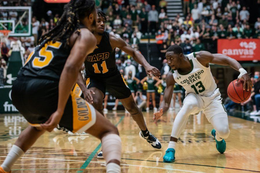 Fifth-year Chandler Jacobs (13) dribbles through defenders towards the net in the second half Nov. 12. (Lucy Morantz | The Collegian)