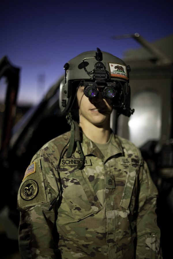 Quinn Schneider, a Colorado State University Army Reserve Officers Training Corps junior, wears a flight helmet equipped with night-vision goggles (NODs) in front of a UH-60L Black Hawk helicopter parked on the CSU Intramural Fields Nov. 13. The helicopter was requisitioned by the CSU Army ROTC to make an appearance for military appreciation day as well as CSUs football game against the United States Air Force Academy, which resulted in a win for Air Force 35-21.