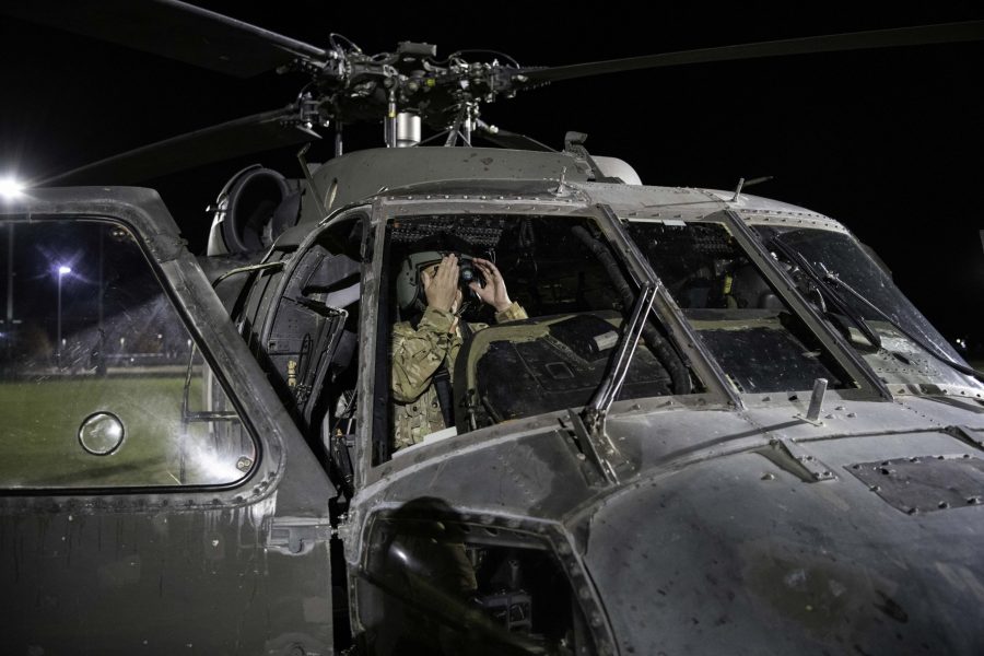 Pilot Chief Warrant Officer 2 Nathan Bosso of the 4th Combat Aviation Brigade prepares his night-vison goggles in the cockpit of a UH-60L Black Hawk before taking off from the Colorado State University Intermural Fields Nov. 13. CW2 Bosso stated, “The timing of everything. So, after sunset it gets dark to ENT (Entry) where we can fly with our goggles about 48min after sunset. We could night unaided if we want but It is safer to fly with goggles.” The helicopter was requisitioned by the CSU Army ROTC to make an appearance for military appreciation day as well as CSUs football game against Air Force which resulted in a win for Air Force (35-21). (Garrett Mogel | The Collegian)