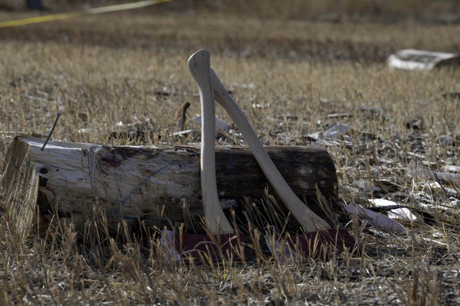 Axes on the ground surrounded by wood ships at a demonstration and community for the Colorado State University logging sports team Nov. 14. The team is nearly 100 years old winning several awards through their years of competition. (Garrett Mogel | The Collegian)