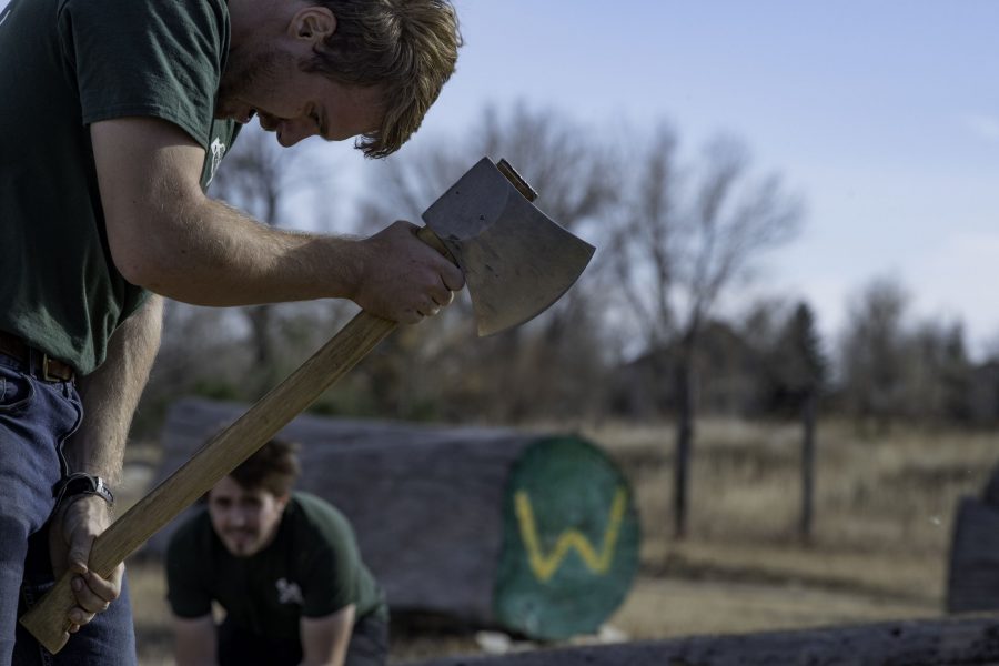 Josh Rudd, a member of the Colorado State University logging sports team swings an axe during a demonstration and community day Nov. 14. The team is nearly 100 years old winning several awards through their years of competition. (Garrett Mogel | The Collegian)