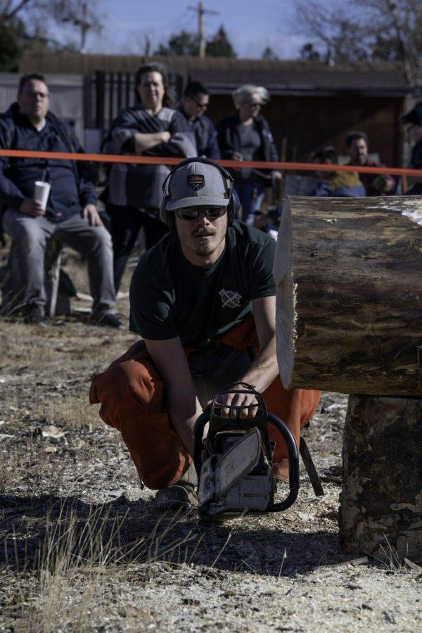 Riley Knap, a member of the Colorado State University logging sports team warms up the chainsaw before cutting Nov. 14. The team is nearly 100 years old winning several awards through their years of competition. (Garrett Mogel | The Collegian)