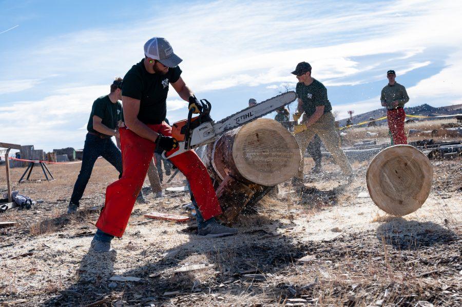 Karson Wilson member of the CSU Logging Team cuts a clean cookie during the stock saw event Nov. 14. (Milo Gladstein | The Collegian)