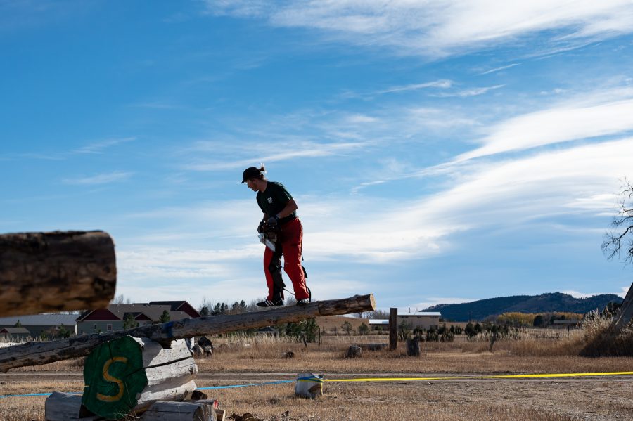 Member of the CSU Logging Team Nate Sivers tests out the Obstacle Poll event Nov. 14. (Milo Gladstein | The Collegian)