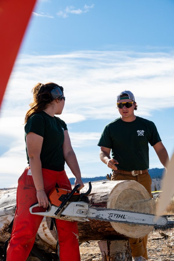 Miranda Zuvich, President of the CSU Logging Team and Chris Graham Vice President of the team exchange a few words before the stock saw event Nov. 14. Graham stated, “I started because I had a buddy in the forestry college and we heard about it through one of their career community days. We saw the table and just decided to come and try it.” (Milo Gladstein | The Collegian)