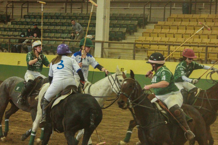 Player three on the opposing team fights to keep the ball in their possession.