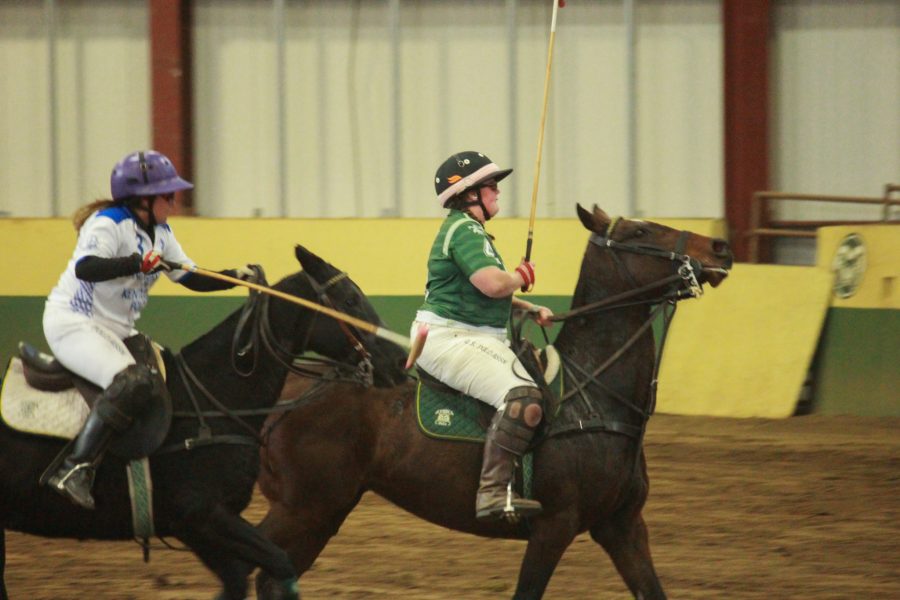 Two players race to get the ball first.