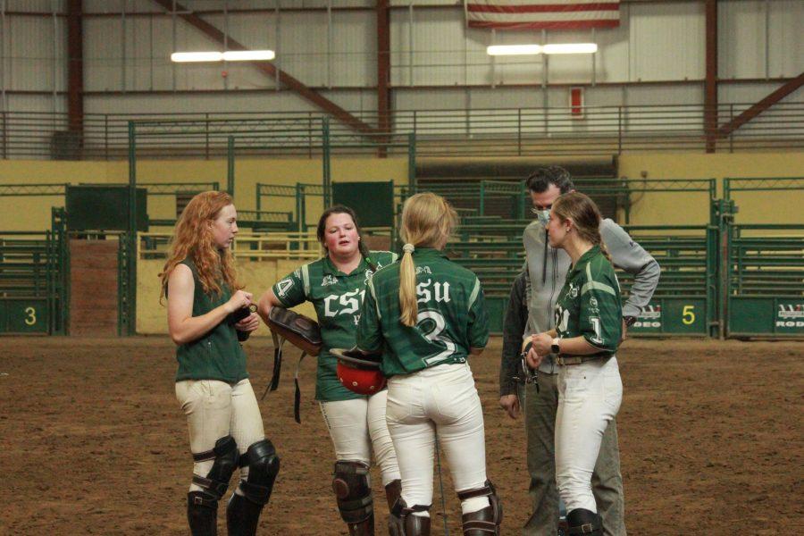The Colorado State Polo team talks with their coach after a win against the University of Kentucky.