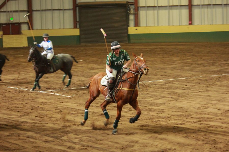A CSU player leads the group as she races after the ball.