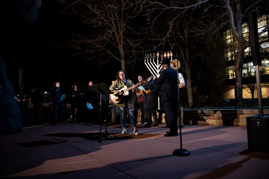 Leora Greene, co-president of Hillel plays the guitar and sings Hanukkah songs in the Lory Student Center, Fort Collins Colorado Plaza Nov. 30. The celebration was organized by the Chabad Jewish Student Organization. (Milo Gladstein | The Collegian)