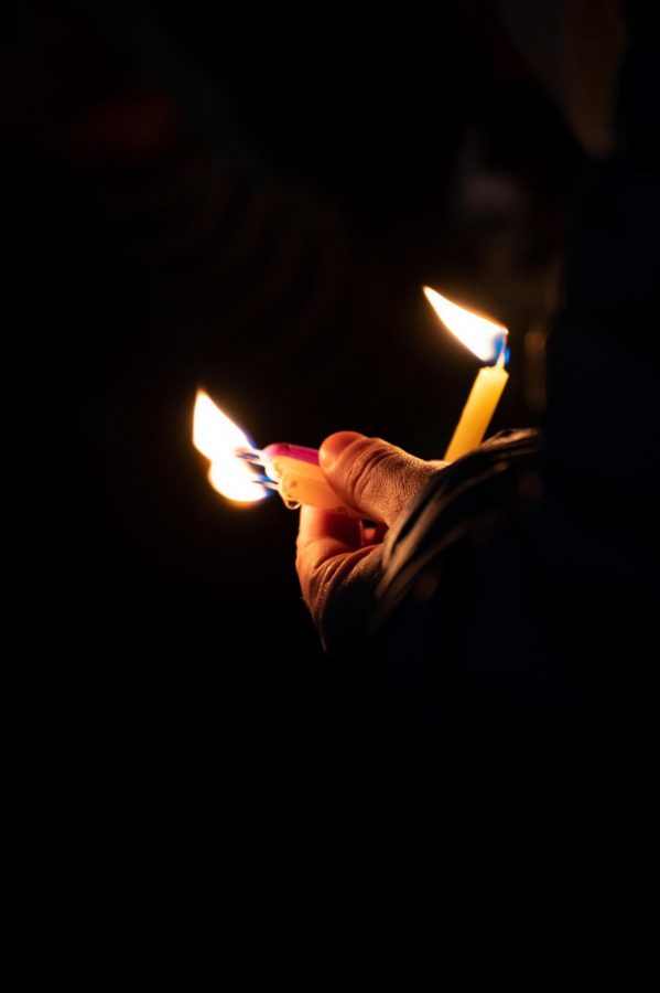 A participant holds three candles in celebration of the third night of Hanukkah held in the Lory Student Center Plaza, Fort Collins Colorado Nov. 30. Joyce Mcconnell had the honor of lighting the menorah. (Milo Gladstein | The Collegian)