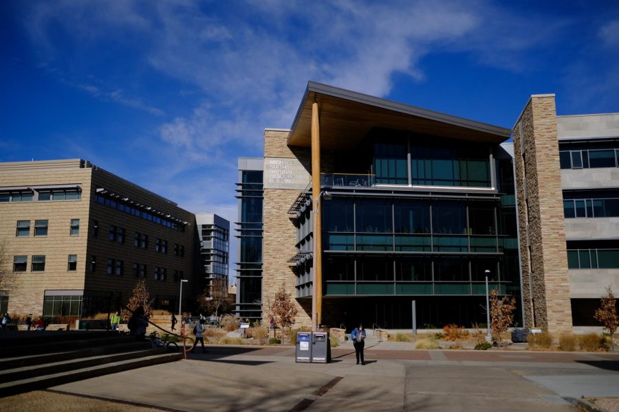 People walk in front of The Warner College Michael Smith building Nov. 20.