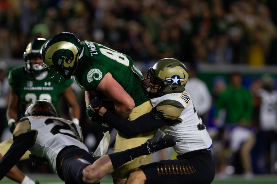 Colorado State tight end Trey McBride hauls in a pass as defensive back Tre Bugg III tackles him Nov. 13