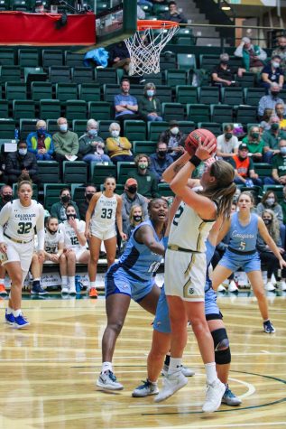 Karly Murphy (42), steps back and shoots over a few defenders. Photographer: Avery Coates