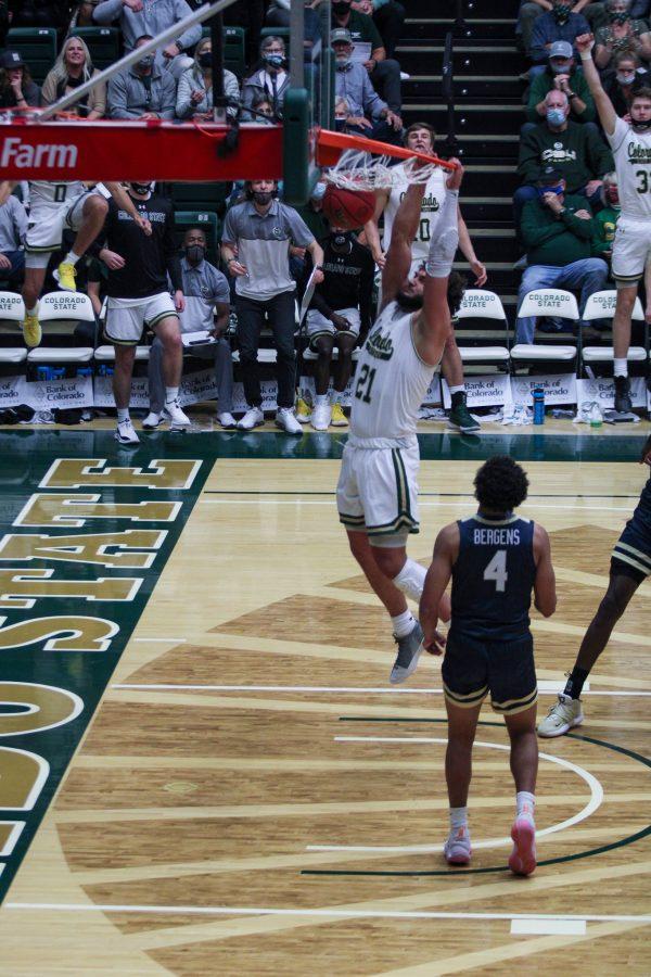 Colorado State University Forward David Roddy (21) dunks the ball while a defender looks on during the CSU home opener game vs Oral Roberts University. Colorado State takes down Oral Roberts 109-80. (Avery Coates | The Collegian)