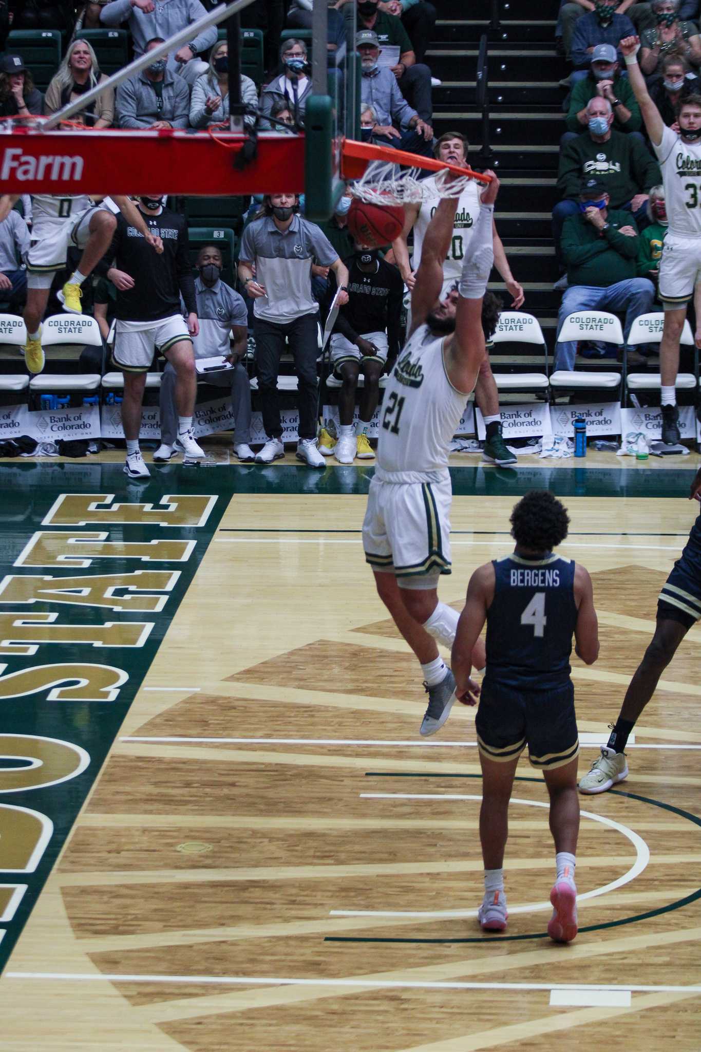 Colorado State Forward David Roddy dunks the ball while a defender watches