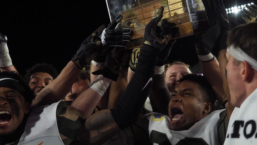 Air Force Academy inside linebacker Demonte Meeks raises the Ram-Falcon Trophy Nov. 13.