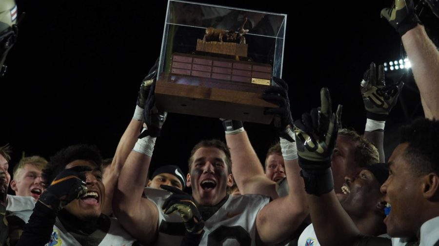 Air Force Academy offensive tackle Ryan Booth raises the Ram-Falcon trophy Nov. 13.