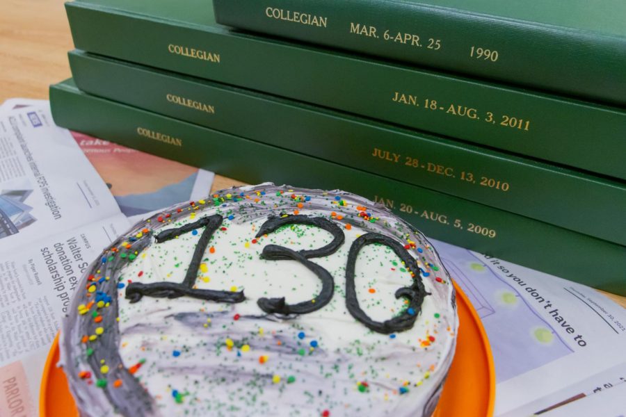 Photo illustration of the collegian's 130th birthday cake surrounded by old copies of the collegian.