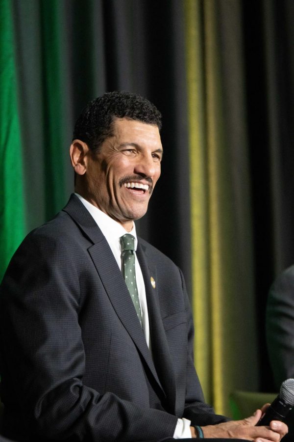 Jay Norvell laughs while speaking to the audience.