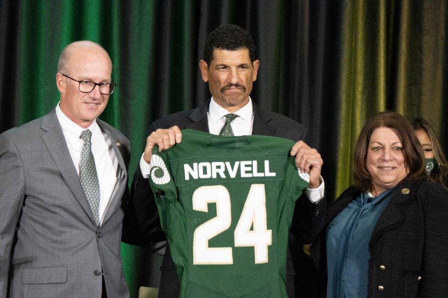 Joe Parker, Jay Norvell and Joyce McConnell pose with Norvell's CSU jersey during his welcome announcement in the Iris and Michael Smith Alumni Center, Dec. 7. 