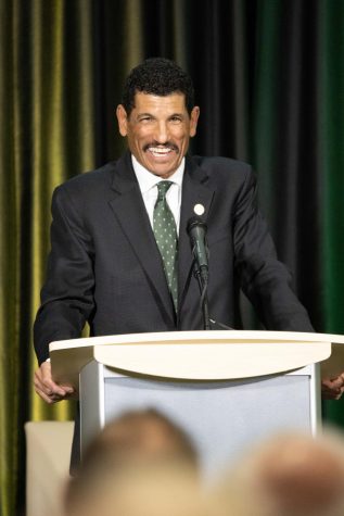 Jay Norvell laughs while speaking to the audience.