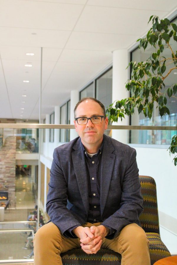 Tom Dunn sits in the Lory Student Center.