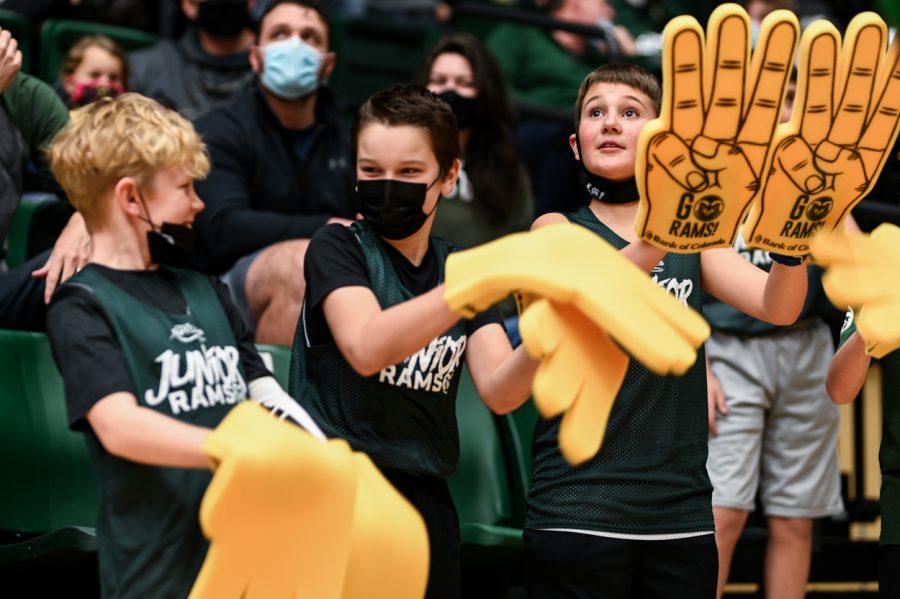 Young Rams fans wave their foam fingers at each other while waiting for the Colorado State University mens basketball team to come out to the court