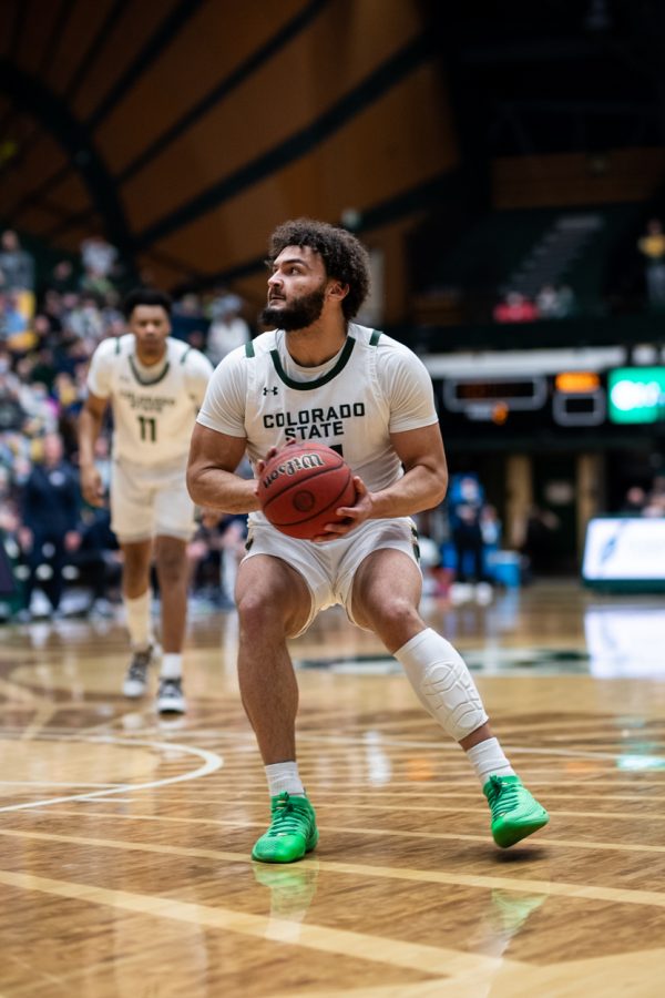 Junior David Roddy (21) looks for a shot against Utah State University