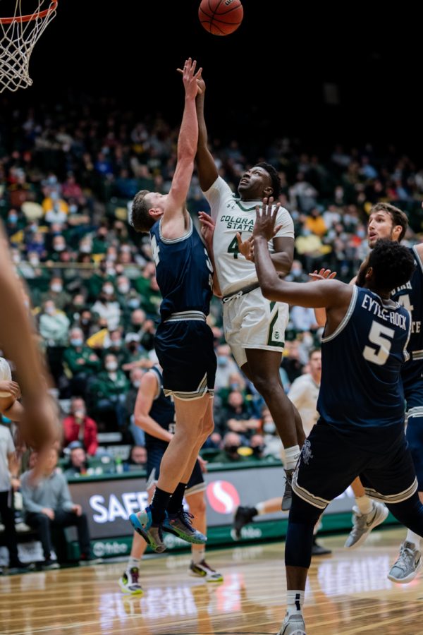 Junior Isaiah Stevens (4) goes up for a layup against Utah State University