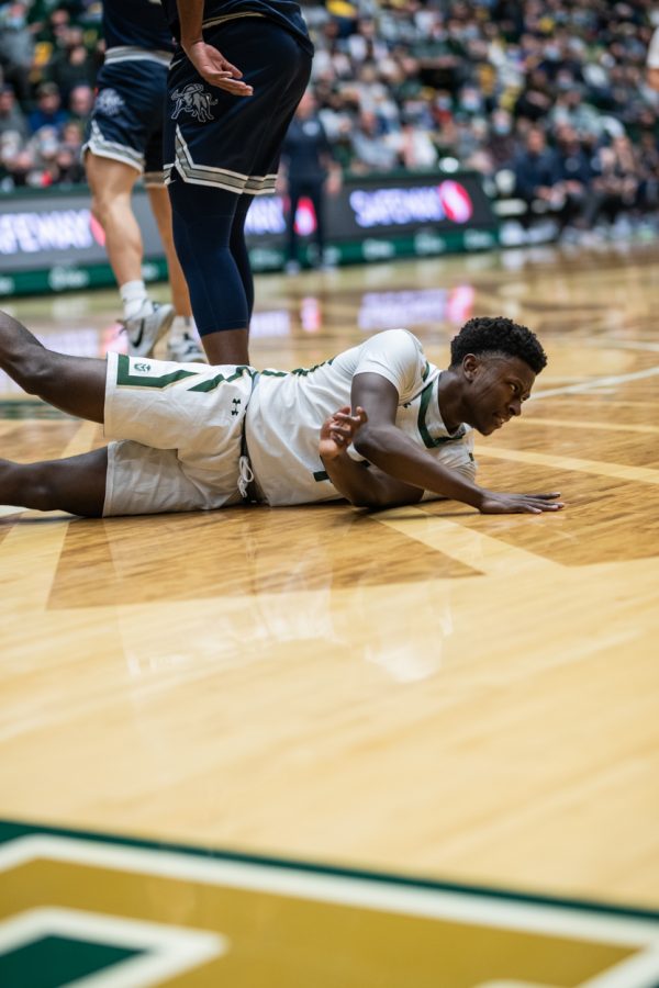 Junior Isaiah Stevens (4) falls after attempting a layup against Utah State University