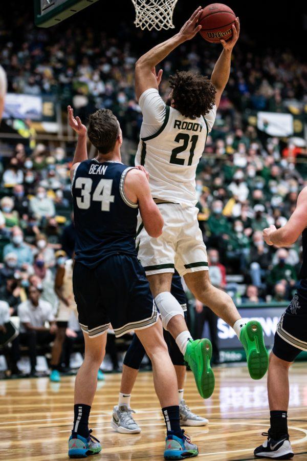 Junior David Roddy (21) makes a dunk in the second half against Utah State University