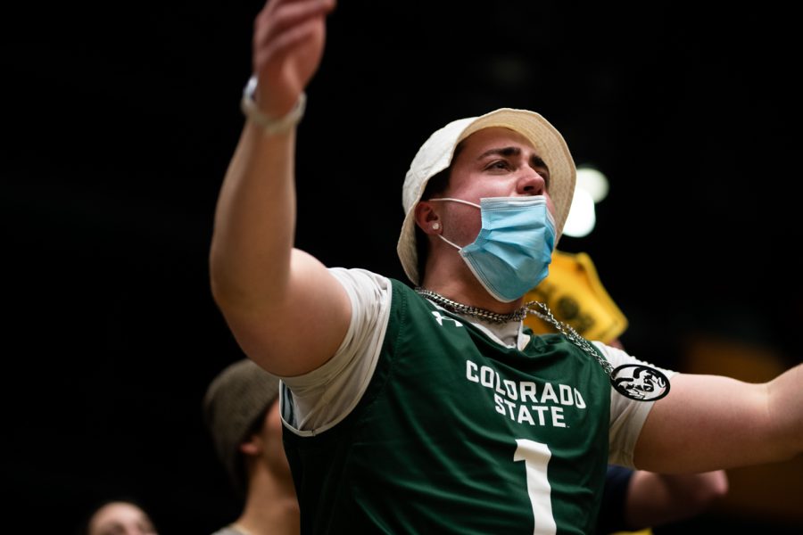 A Colorado State University fan cheers in the student section after CSU made a three-point shot
