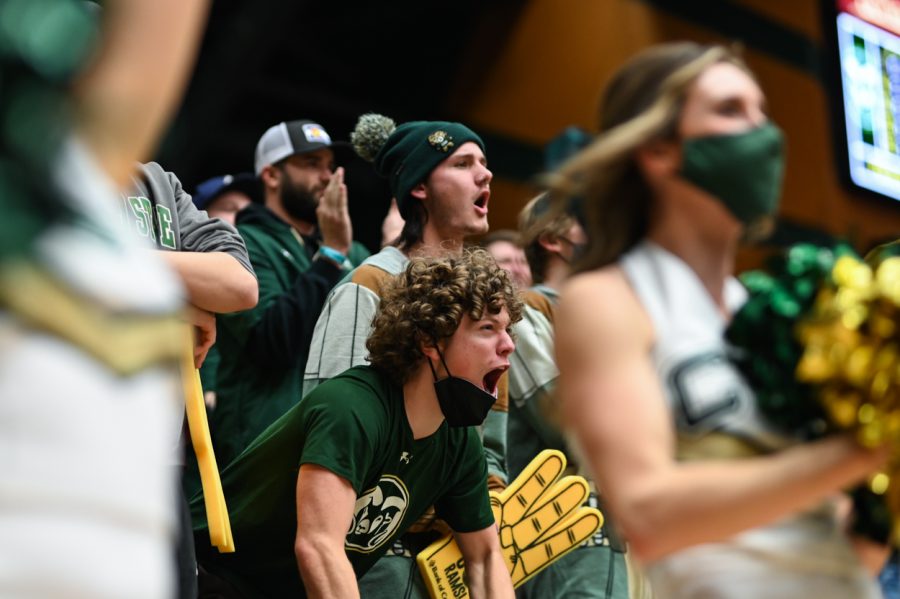 A Colorado State University fan yells from the stands to celebrate a three-point shot