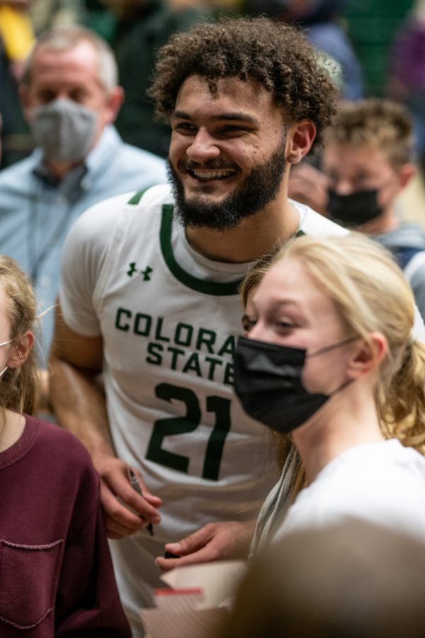 Before making it to the locker room after the final whistle was blown, junior David Roddy (21) poses for photos and signs autographs for fans