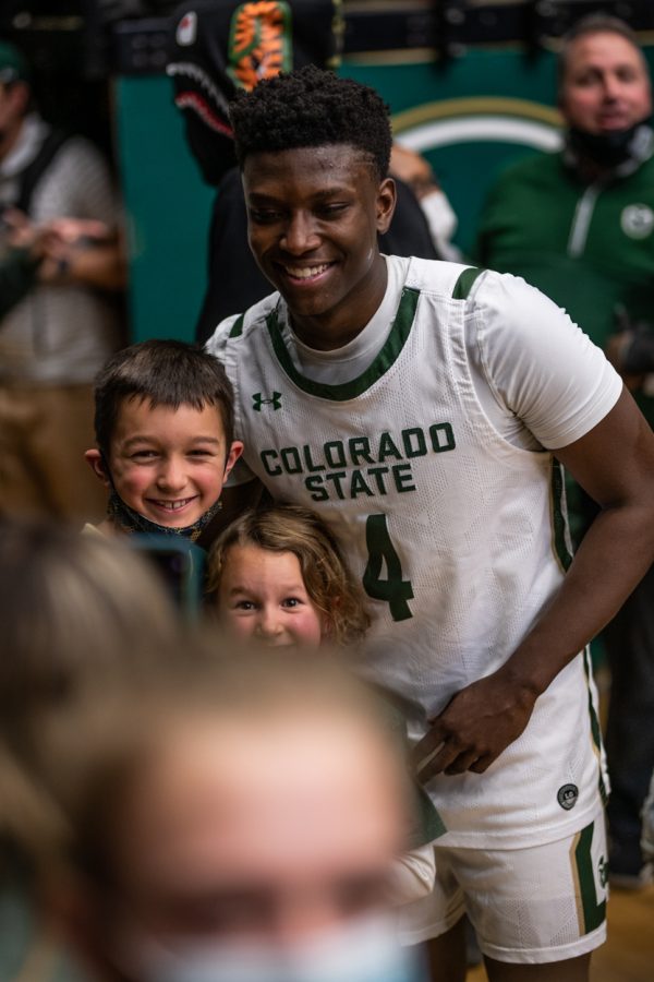 Before making it to the locker room after the final whistle was blown, junior Isaiah Stevens (4) poses for photos and signs autographs for fans