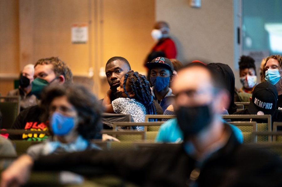 Joey Rucks holds his daughter Georgia Rucks as they listen to a keynote speaker in the Lory Student Center at Colorado State University for the Martin Luther King day celebration Jan. 17.