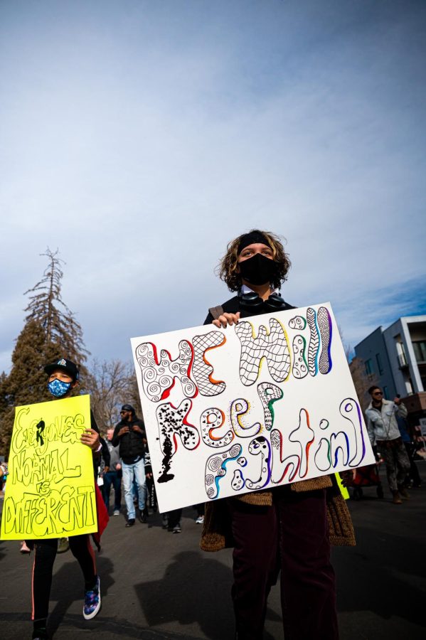 Maya Scott-Donegan is part of the cultural enrichment center. Scott-Donegan holds a sign during the Martin Luther King day celebration through Fort Collins Jan. 17.