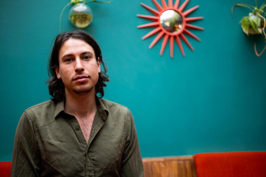 Connor Williams, one of the co-owners of the Atrium, sits in their lounge area in Fort Collins, CO