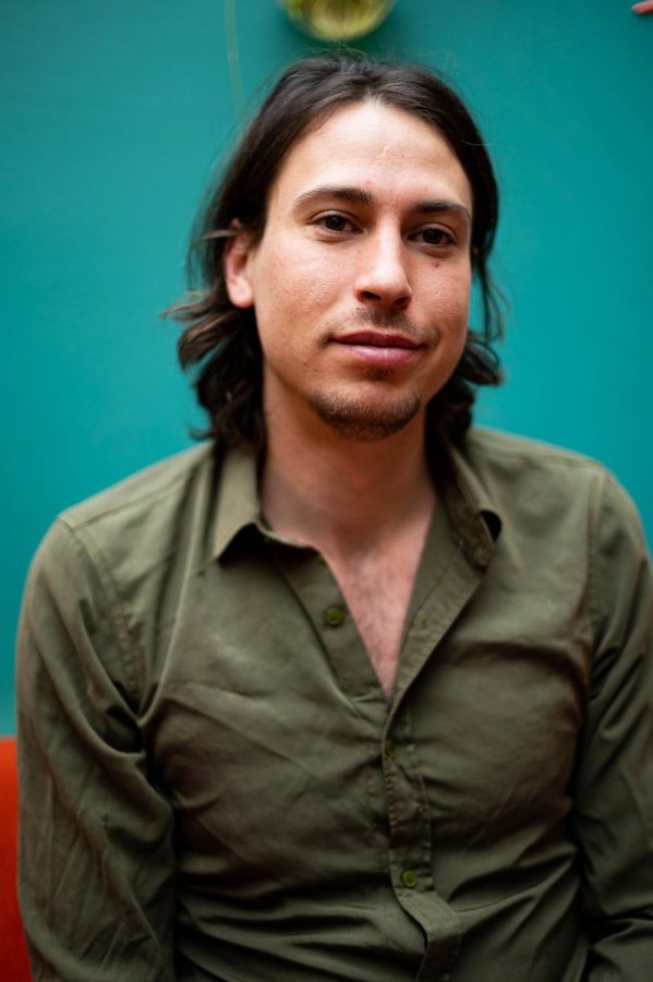 Connor Williams, one of the co-owners of the Atrium, sits in their lounge area in Fort Collins, CO