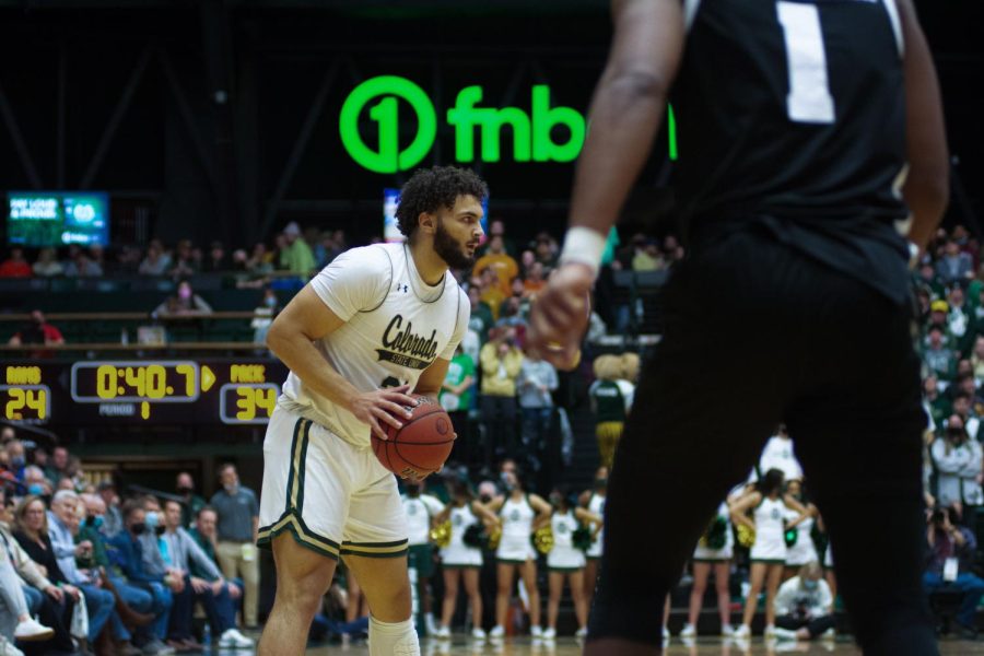 David Roddy (21) looks to pass the ball on offense during a game against the University of Nevada, Reno Wolf Pack. The Colorado State University Rams won 77-66. 