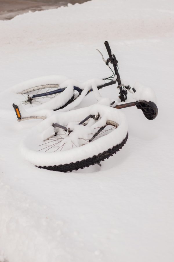 A bike covered in snow on the side of the sidewalk at Colorado State University campus on Jan. 25.