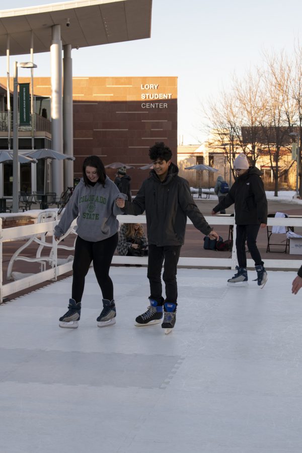 Two Colorado State University students skate on a temporary ice rink outside the CSU Lory Student Center Plaza Jan. 27. 22