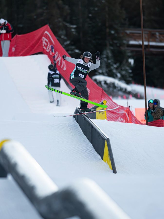 Taylor Lundquist performs a one ski grind on a rail in women’s ski street style finals at Dew Tour