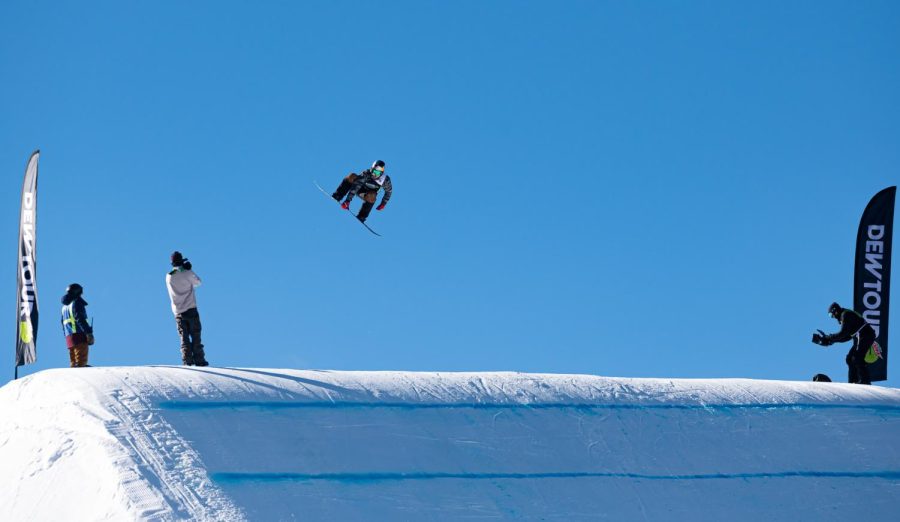 Sebastian Toutant grabs his board off one of the kickers in men’s slopestyle finals at Dew Tour