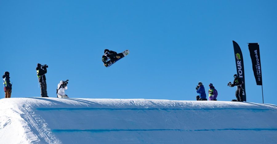Dusty Henricksen spins and grabs the tail of his board off one of the kickers in men’s slopestyle finals at Dew Tour