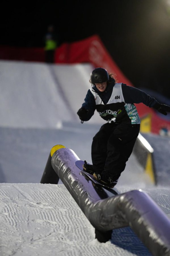 Grace Warner performs a 50-50 grind during women’s snowboard street style finals at Dew Tour
