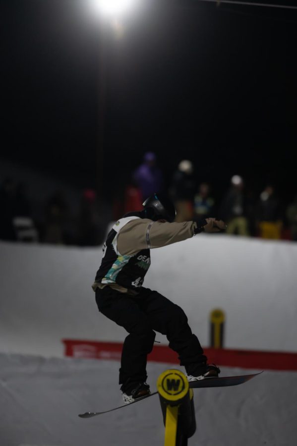 Jesse Paul performs a board slide during men’s snowboard street style finals at Dew Tour