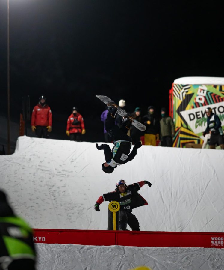 Miles Fallon and Zeb Powell flip together off a rail in men’s snowboard street style finals at Dew Tour Dec. 18.